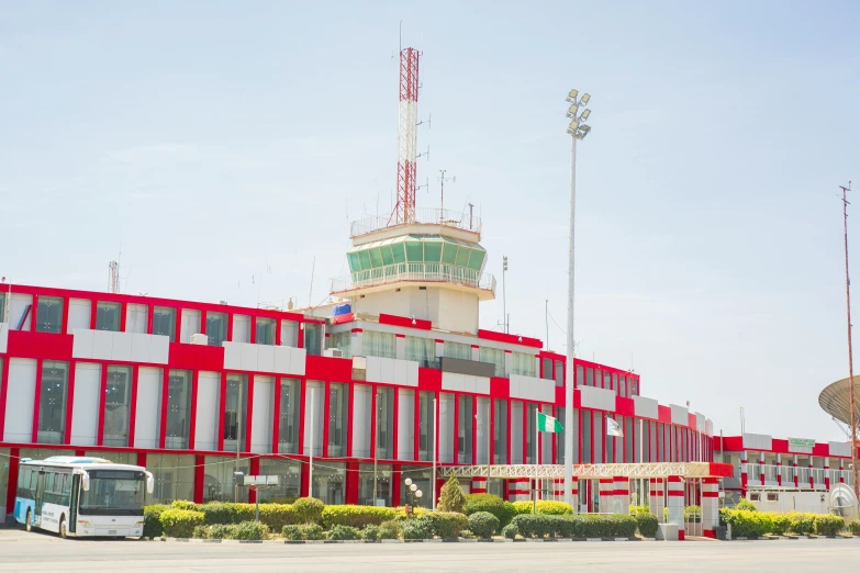 a large red and white building with a large traffic signal on top