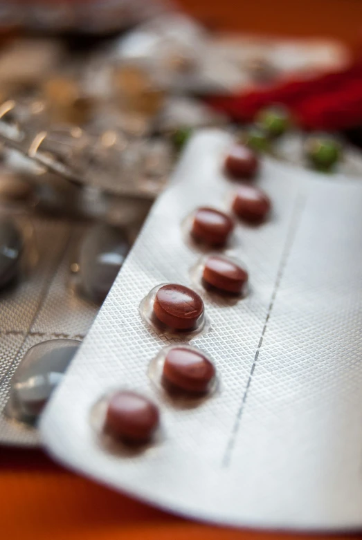 a row of capsule pills sitting on top of a contraption