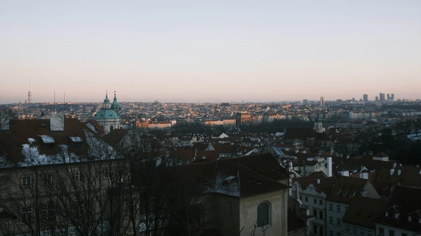 the skyline of an european city with roofs, houses and buildings, looking across at a cloudy sky