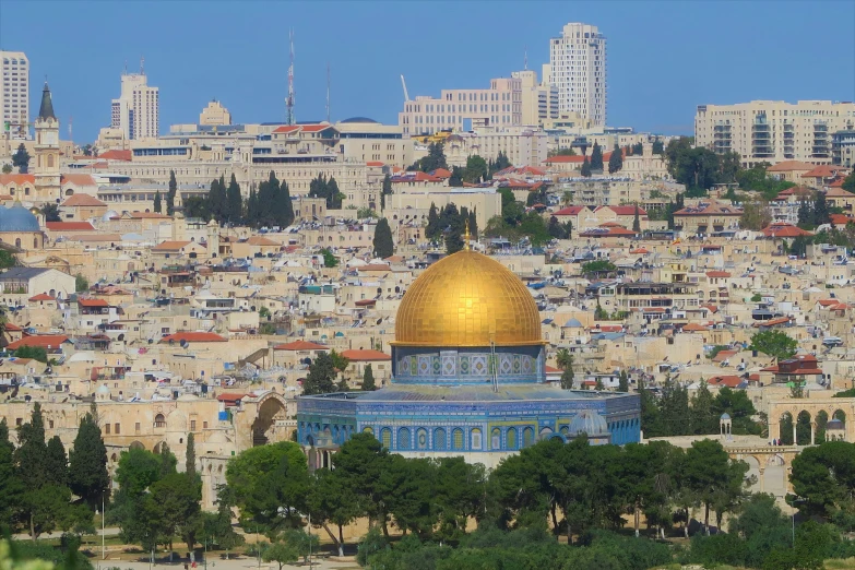 a building with a golden dome is on top of a hill