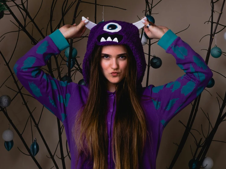 a girl wearing an ugly purple monster costume