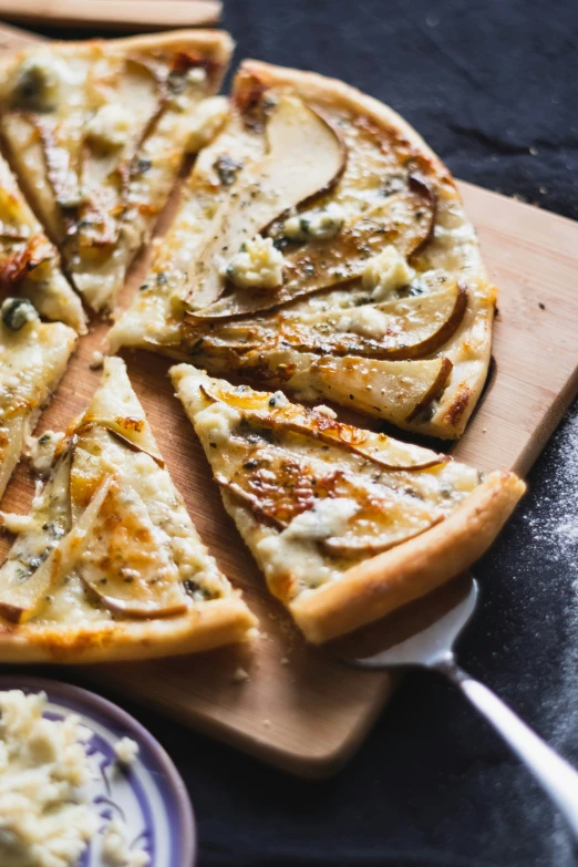 a pizza cut into triangles on a  board