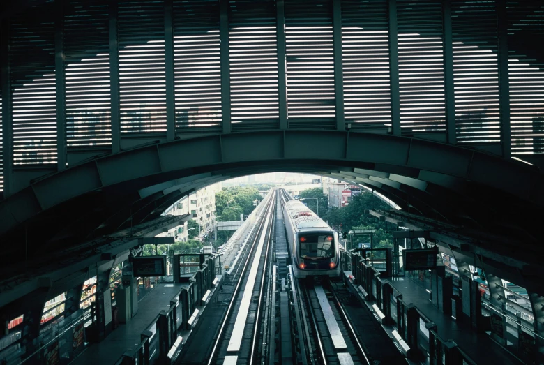 a train is passing under an overhead bridge