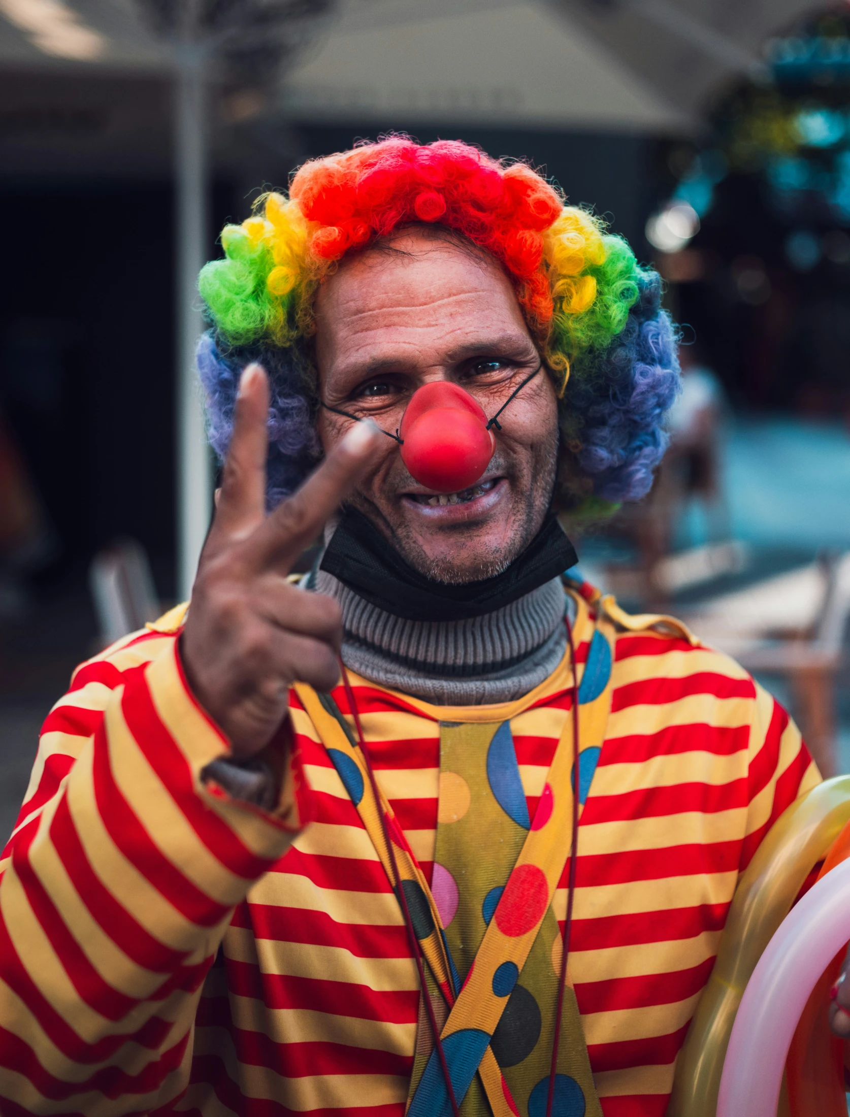 a clown is making an obscene hand signal with his hands