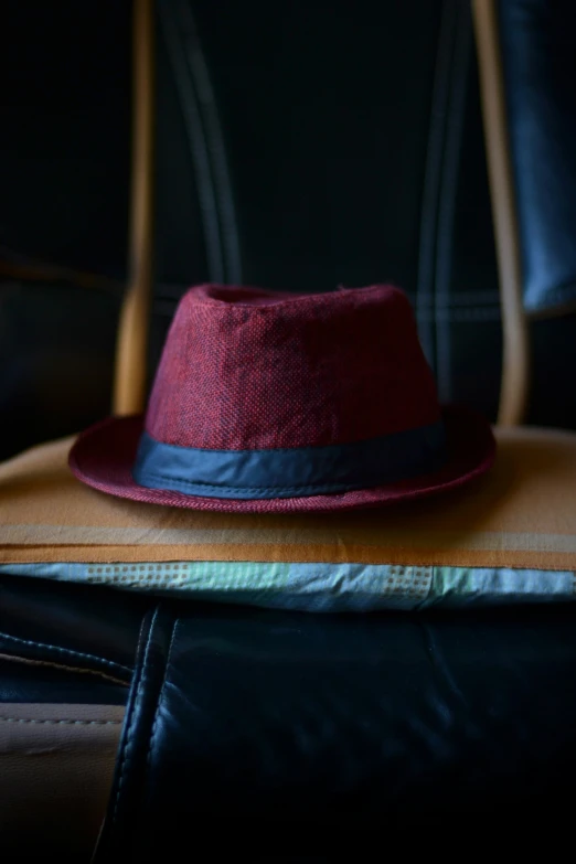 a red hat sitting on top of a brown bag