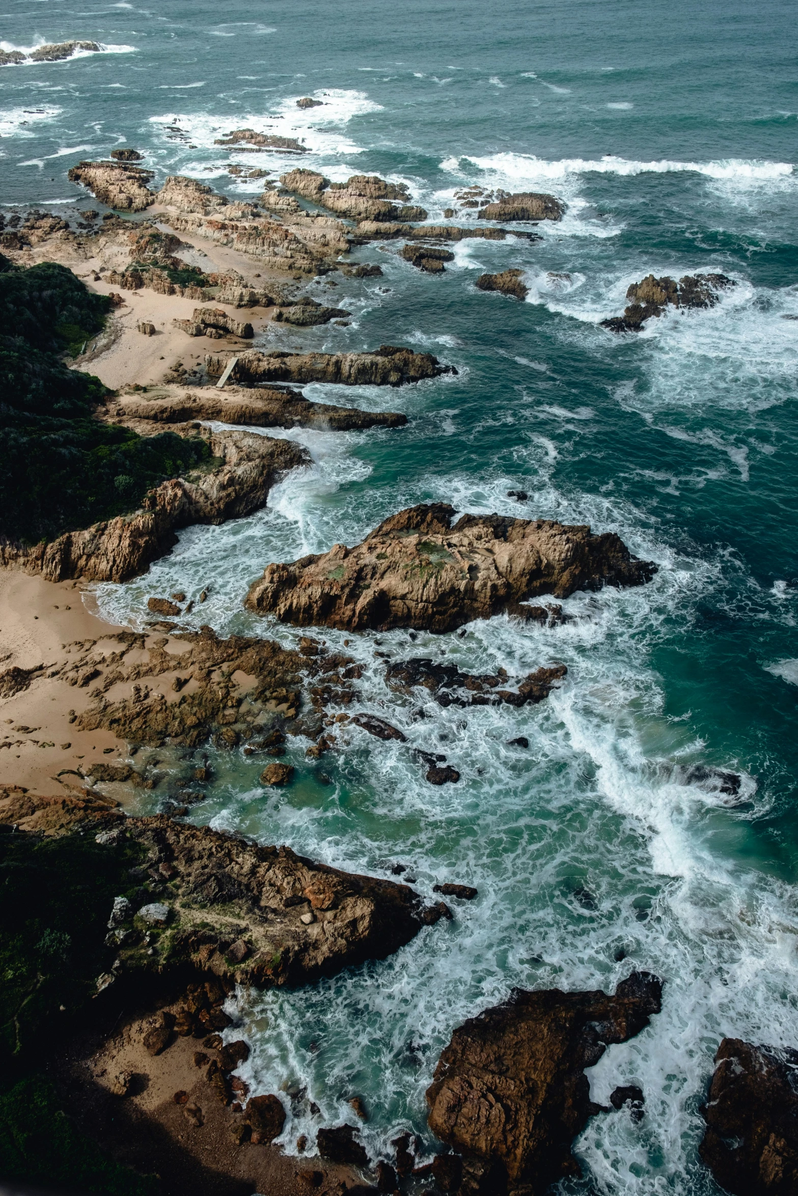 view from an airplane of the rocky coast near the water