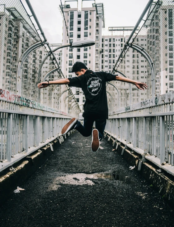 a man riding a skateboard across a bridge