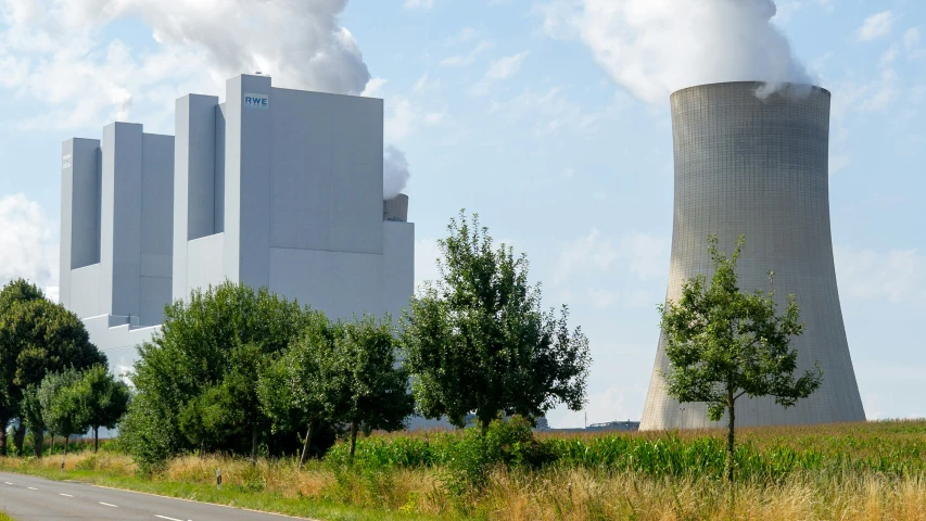 the smoke stacks of factories are seen next to trees