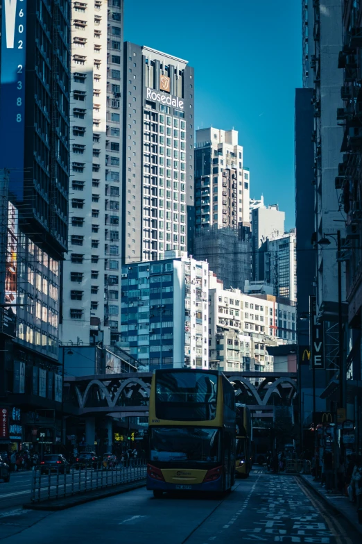 two double decker buses driving down a city street