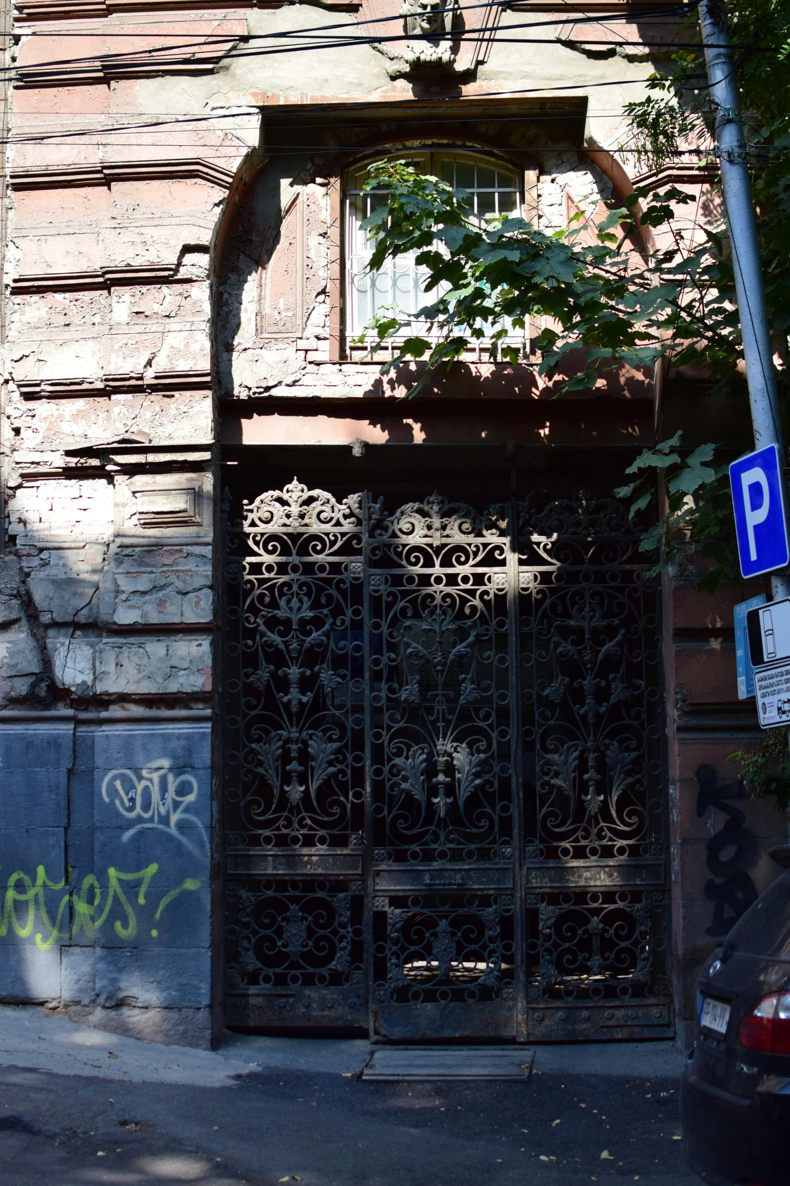 an apartment building with graffiti on it and doors