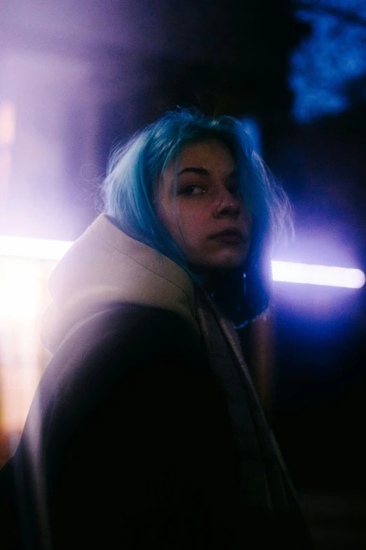 a woman with blue hair staring off into the distance