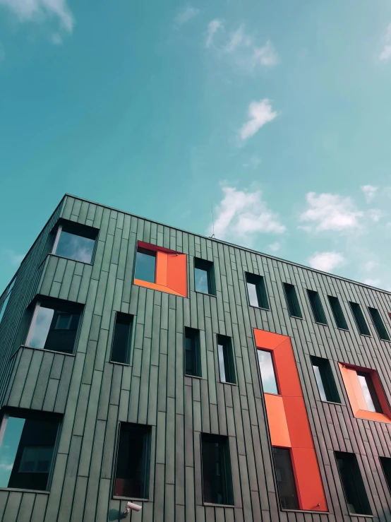 a large building with orange windows on the outside