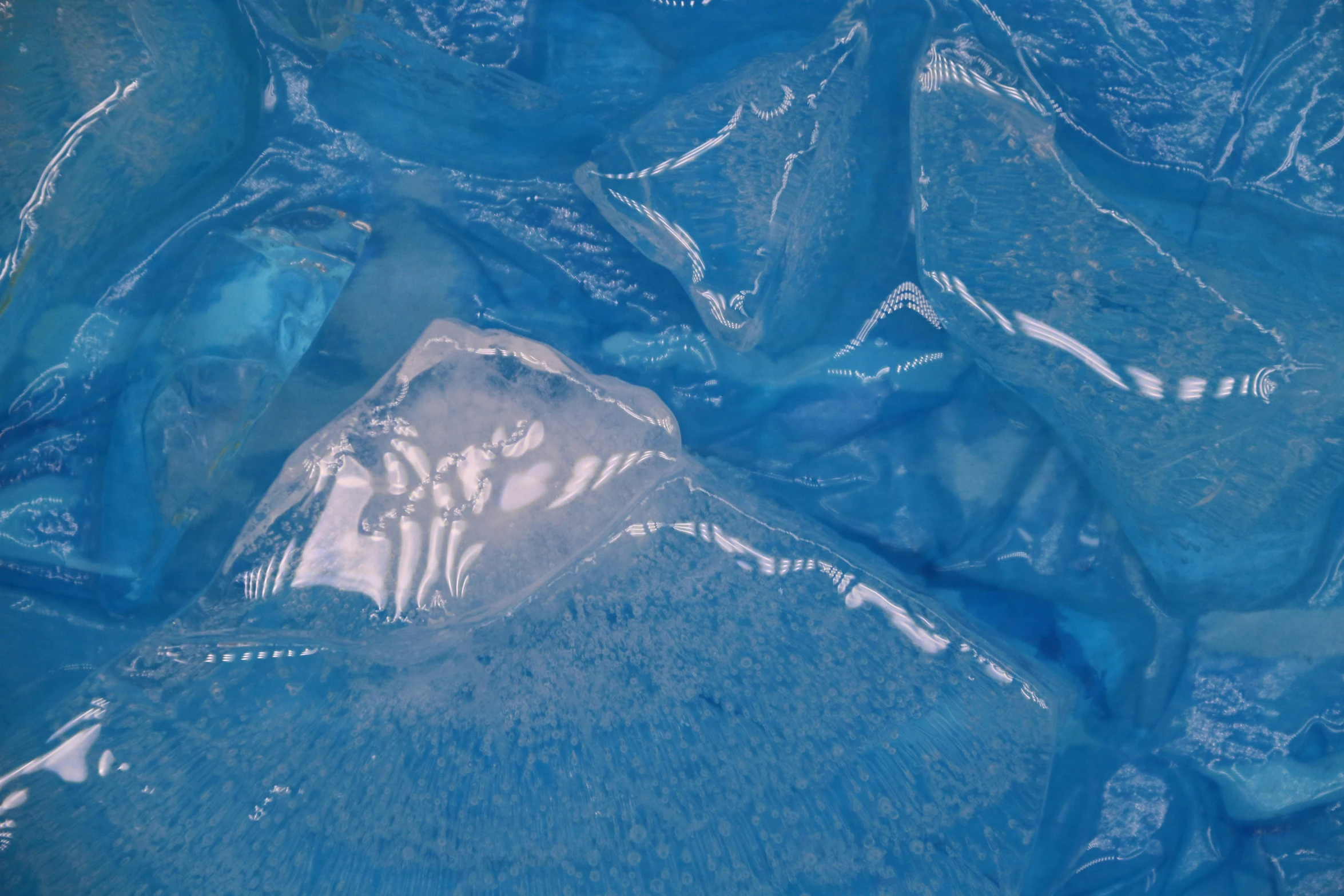 the image shows blue plastic wrap and a white plastic object