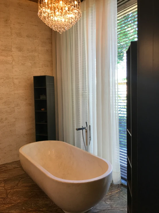 the large bath tub is beside the window