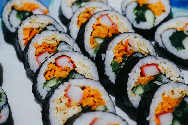 a variety of sushi displayed on white paper