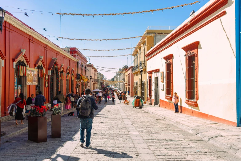 people are walking along the small street