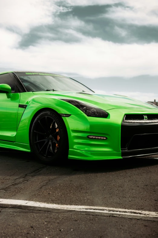 this is a green sports car parked on a runway