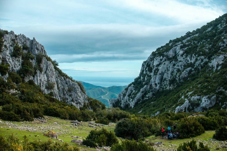 two people are looking down at the view of a valley