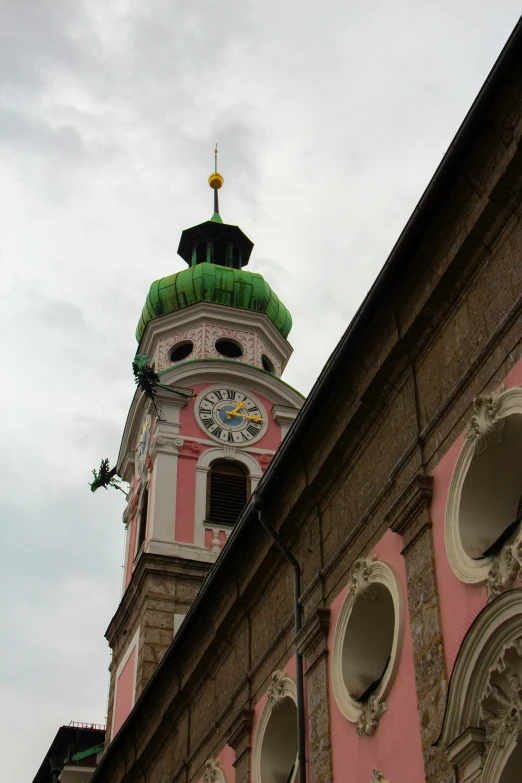 a church clock tower on top of an old building