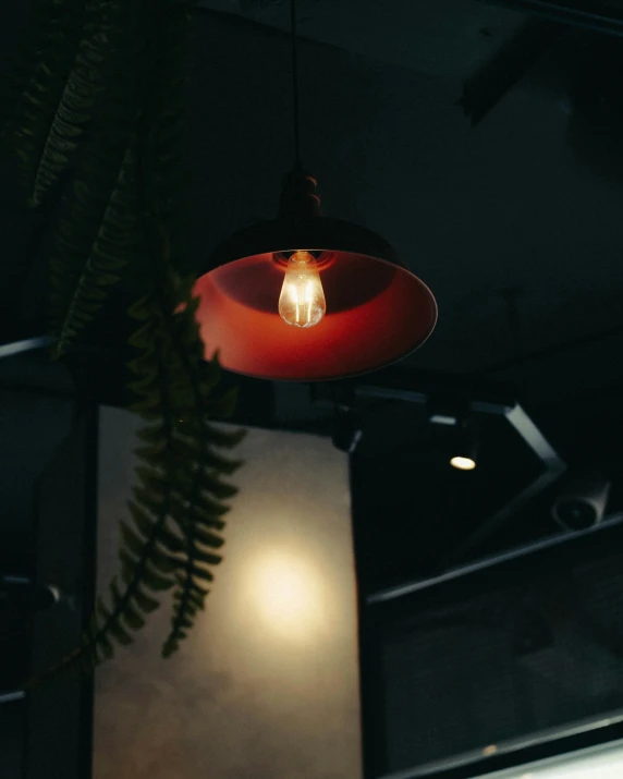 a hanging light hanging over a table in a restaurant