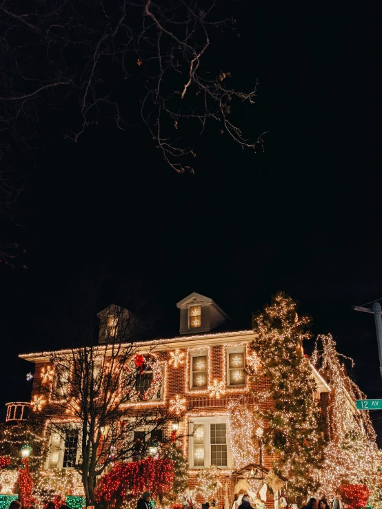 a beautiful home covered in lights at night