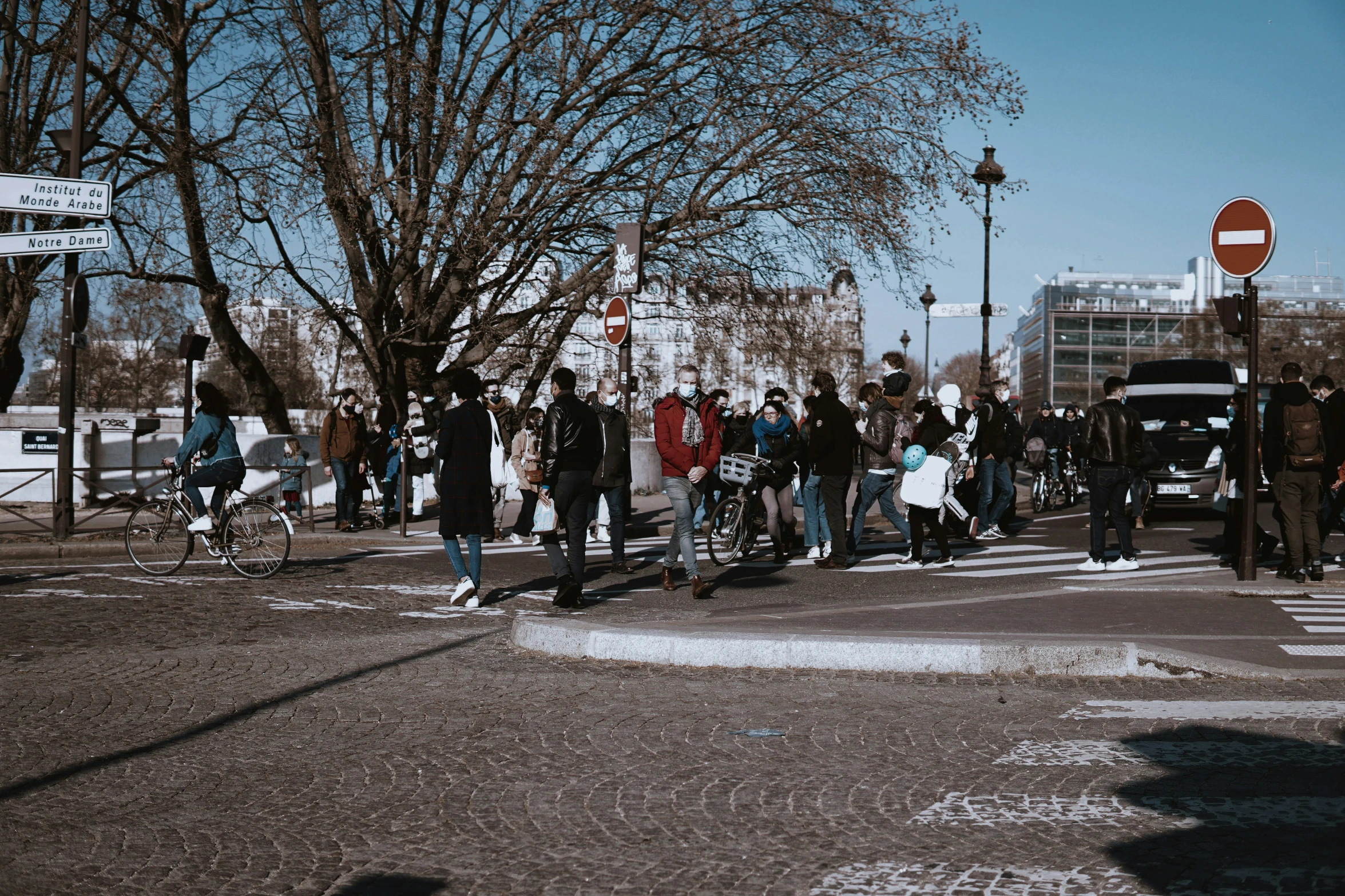 a crowd of people are walking across the street