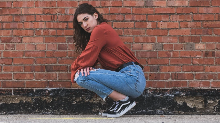 a woman sitting down on the ground