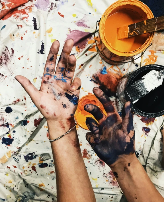 hands with painted nails on their and in various buckets