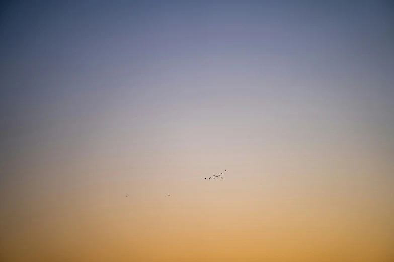 a small plane flying high up in the sky