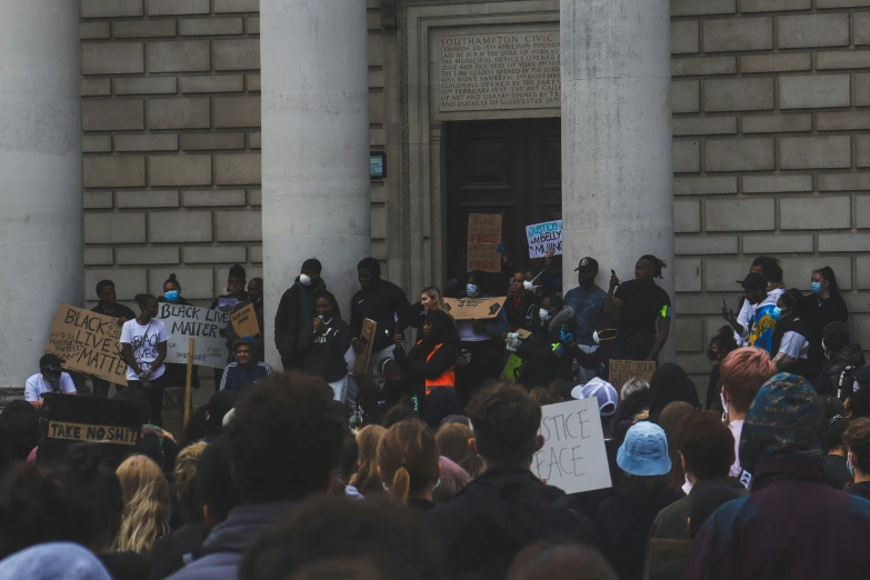 a large crowd of people at a public rally