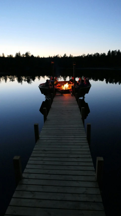 a dock with two boats parked on the lake