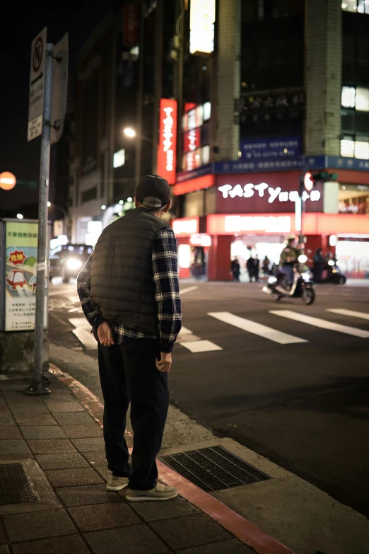 a man is looking out on a street corner