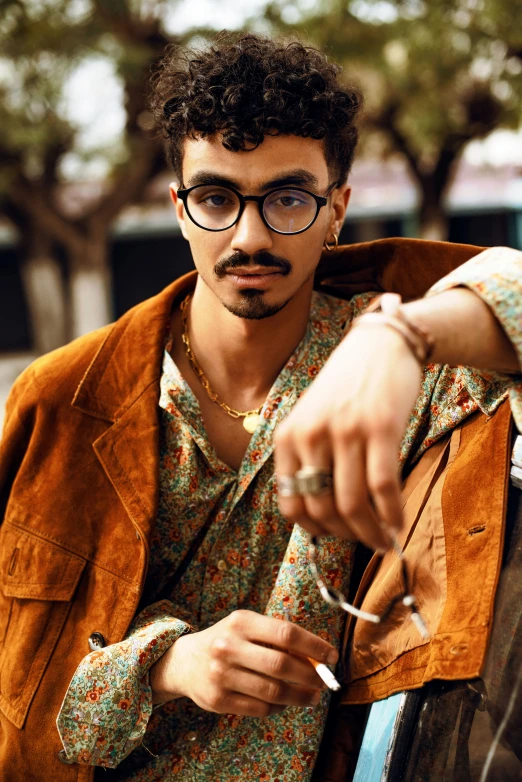 a young man holding scissors with an odd look on his face