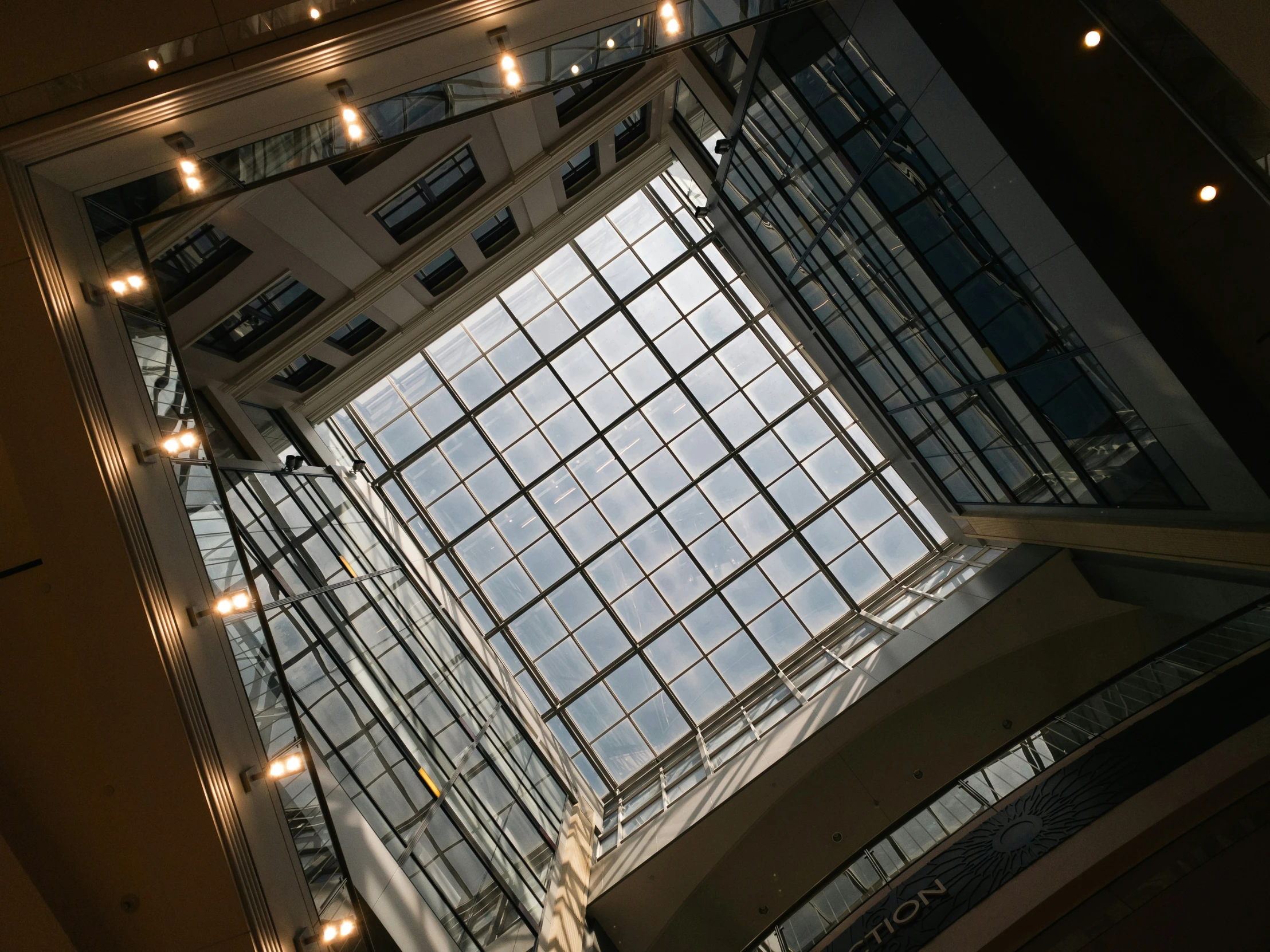 the inside of a building with lots of windows and lights