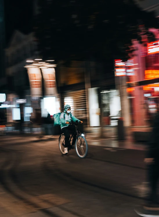 blurred po of the street at night with a person on a bike