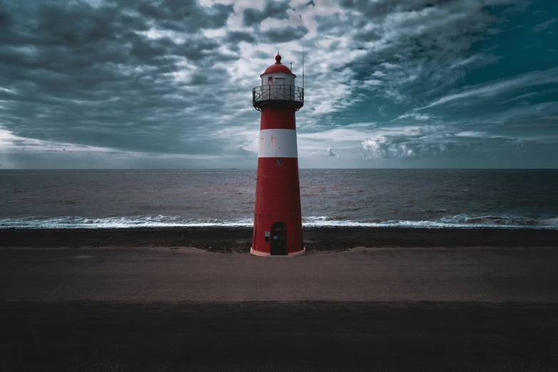 a small lighthouse sitting in front of the ocean