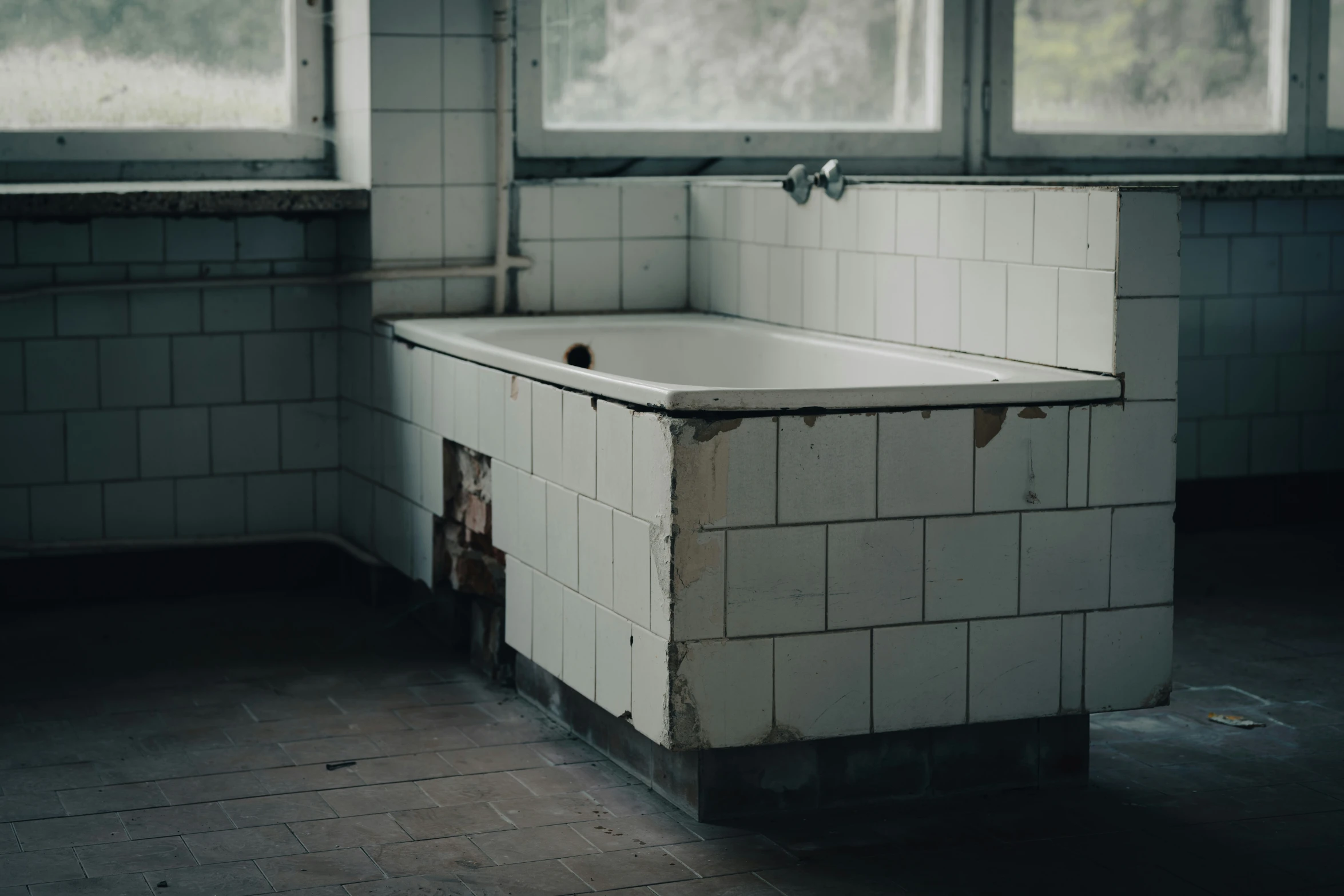 an old, dirty white tub sitting in a dirty bathroom