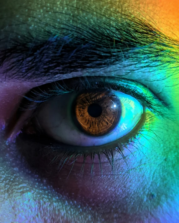 someones eye showing bright rainbow colors