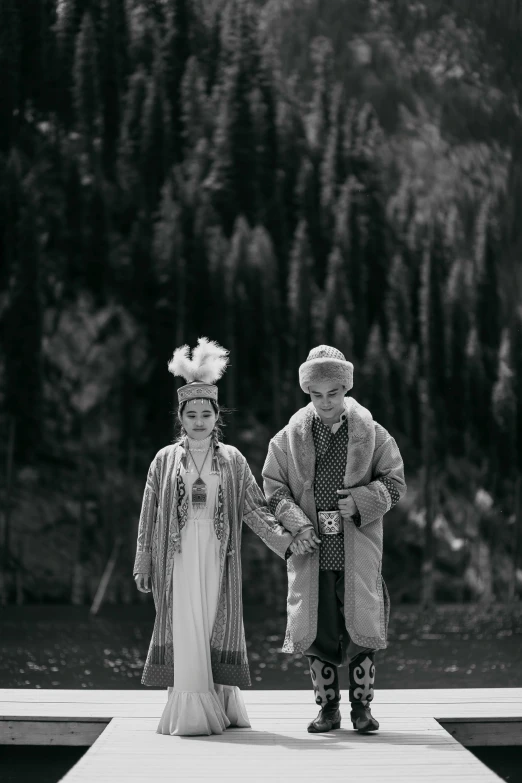 a man and woman are standing on a pier