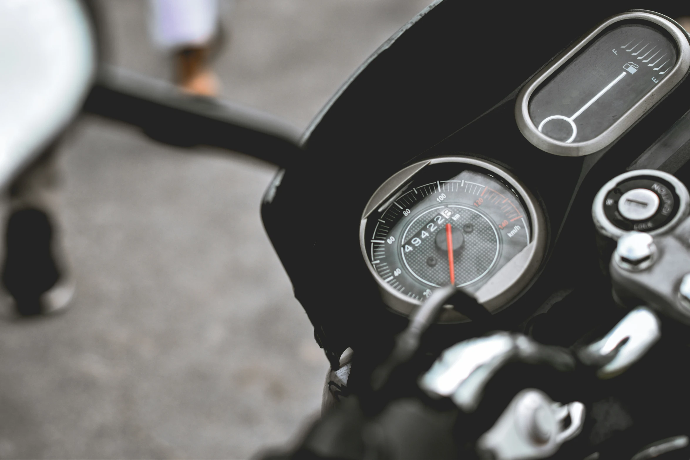 the motorcycle dashboard of a motorbike in front of people