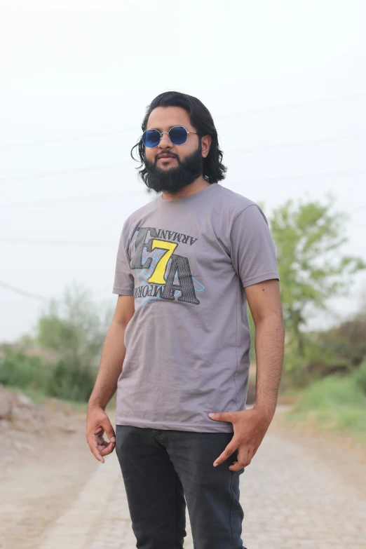 a man wearing sunglasses and standing on a skateboard