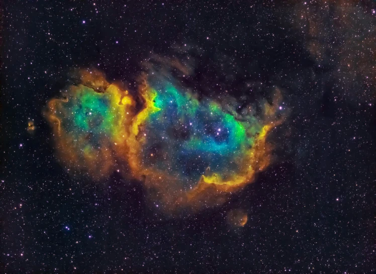 a very large colorful object surrounded by stars in the sky