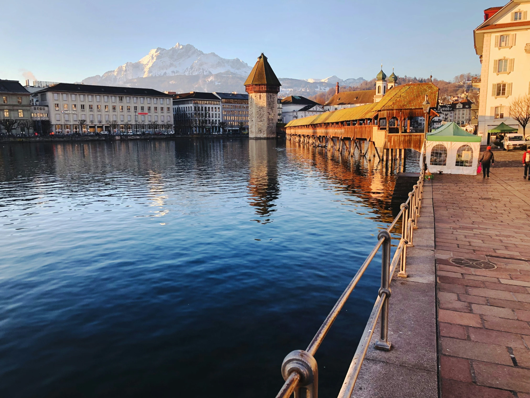 a pier sitting between buildings next to a lake