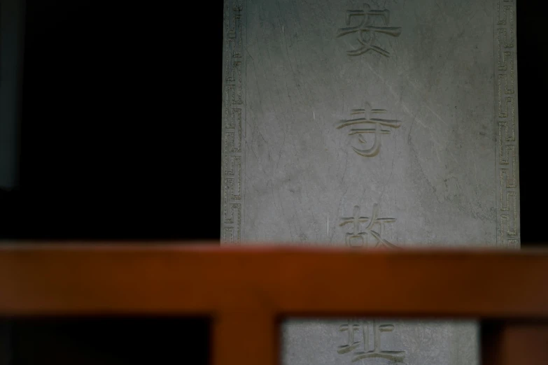 carved stone wall with oriental characters inlayed into it