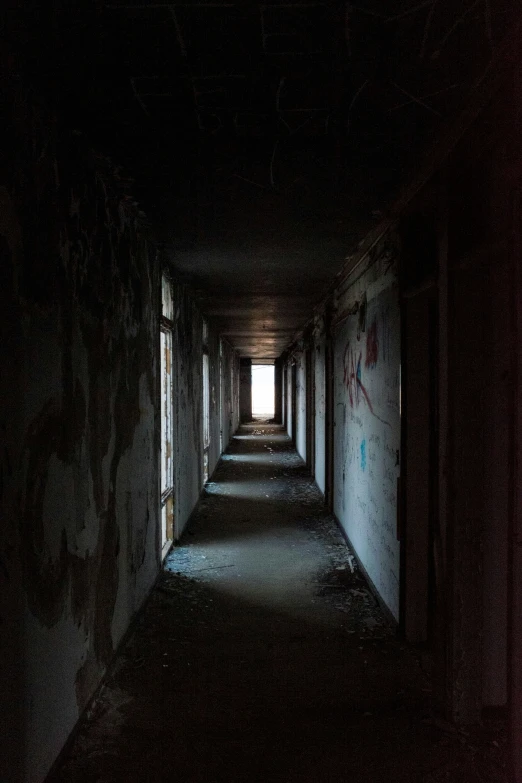 the dark hallway with light coming through the center