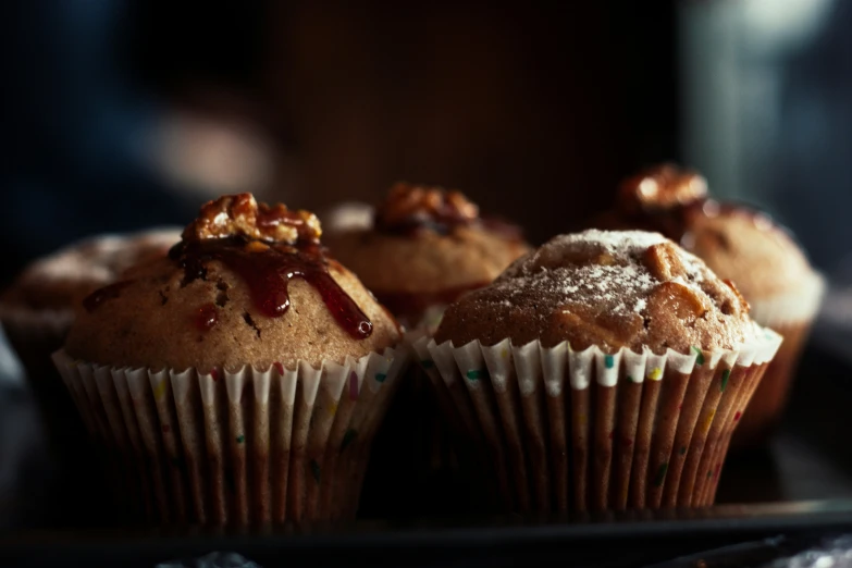 there are three muffins covered in chocolate sitting on the tray