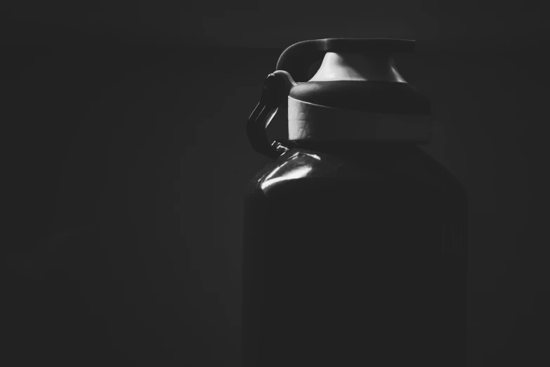 a black water bottle sitting in the dark