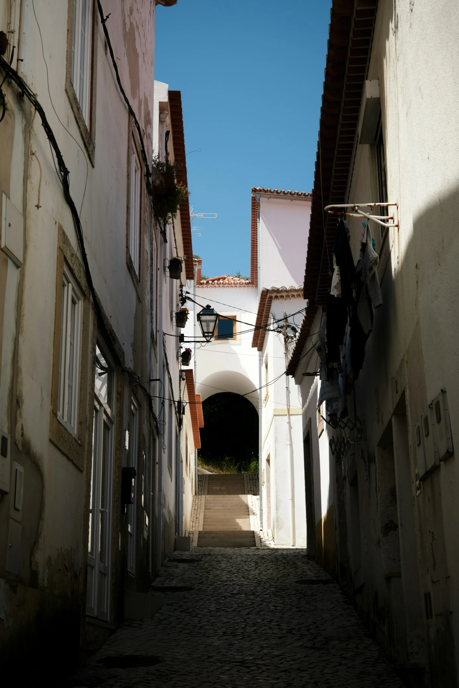 a narrow city street with lots of windows