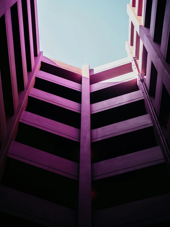 looking upward at the sky from below buildings