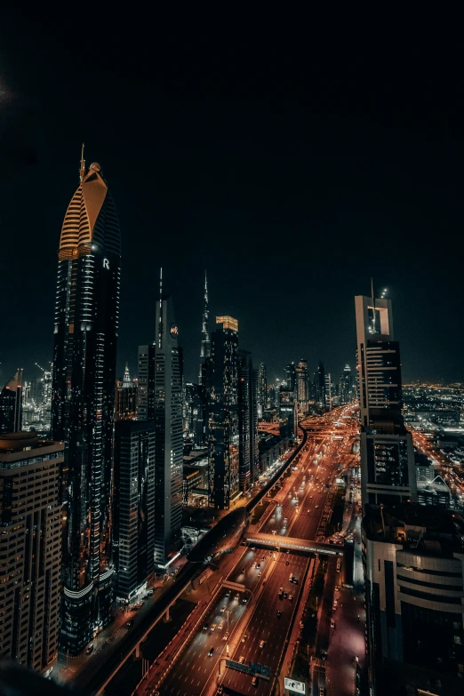 there are many different buildings at night and the streets are lined with traffic